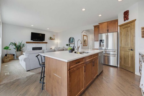 71 Pantego Way Nw, Calgary, AB - Indoor Photo Showing Kitchen With Fireplace With Stainless Steel Kitchen With Double Sink