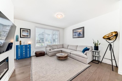 38 Precedence Glen, Cochrane, AB - Indoor Photo Showing Living Room With Fireplace