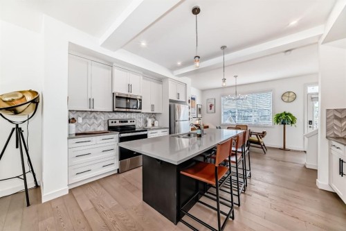 38 Precedence Glen, Cochrane, AB - Indoor Photo Showing Kitchen With Upgraded Kitchen