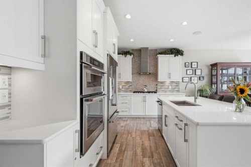27 Sundown Way, Cochrane, AB - Indoor Photo Showing Kitchen With Double Sink With Upgraded Kitchen