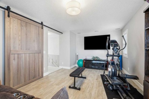 27 Sundown Way, Cochrane, AB - Indoor Photo Showing Gym Room