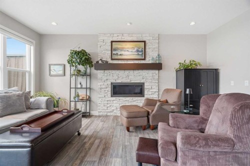 27 Sundown Way, Cochrane, AB - Indoor Photo Showing Living Room With Fireplace