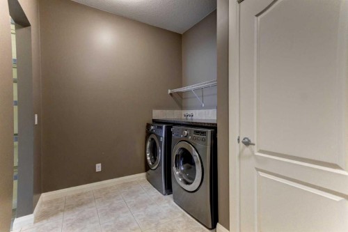 406 Silverado Boulevard Sw, Calgary, AB - Indoor Photo Showing Laundry Room