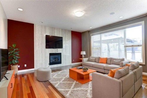 406 Silverado Boulevard Sw, Calgary, AB - Indoor Photo Showing Living Room With Fireplace