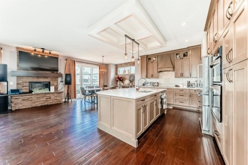 40 Cooperstown Place Sw, Airdrie, AB - Indoor Photo Showing Kitchen With Fireplace With Upgraded Kitchen