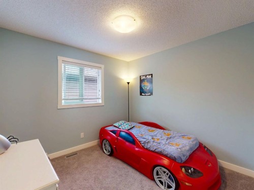 122 Midtown Boulevard Sw, Airdrie, AB - Indoor Photo Showing Bedroom