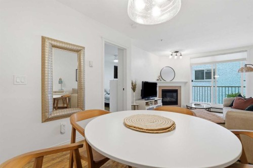 202-1833 11 Avenue Sw, Calgary, AB - Indoor Photo Showing Dining Room With Fireplace