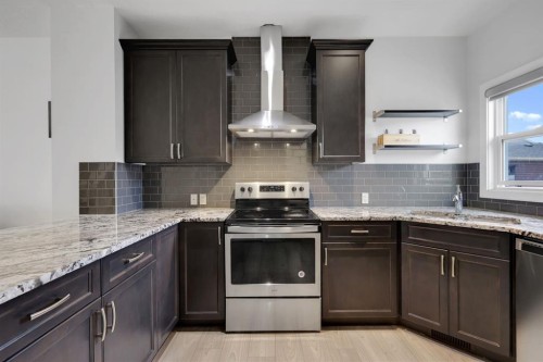 56 Corner Meadows Park Ne, Calgary, AB - Indoor Photo Showing Kitchen With Stainless Steel Kitchen With Double Sink With Upgraded Kitchen