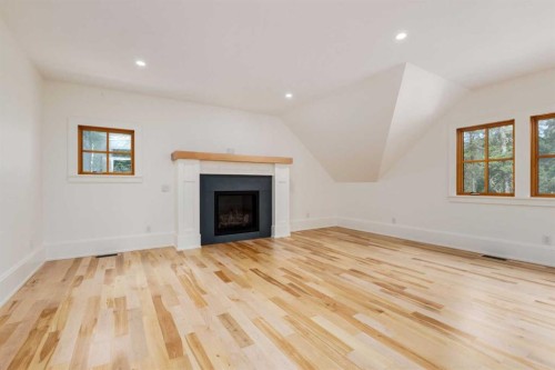 212 Hawk'S Landing Rise, Priddis Greens, AB - Indoor Photo Showing Living Room With Fireplace