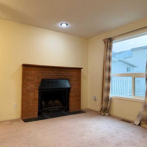 411 6 Street Ne, Calgary, AB - Indoor Photo Showing Living Room With Fireplace