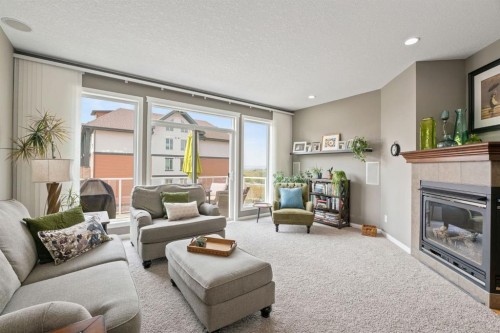 204 Sunset Square, Cochrane, AB - Indoor Photo Showing Living Room With Fireplace