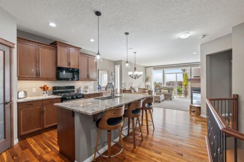 204 Sunset Square, Cochrane, AB - Indoor Photo Showing Kitchen With Upgraded Kitchen
