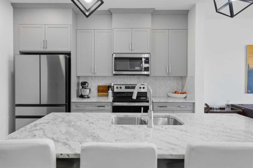 144 Amblehurst Green Nw, Calgary, AB - Indoor Photo Showing Kitchen With Stainless Steel Kitchen With Double Sink With Upgraded Kitchen