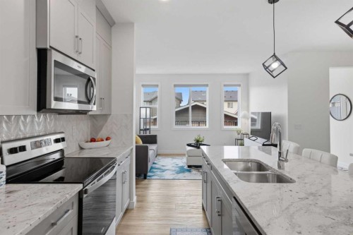 144 Amblehurst Green Nw, Calgary, AB - Indoor Photo Showing Kitchen With Stainless Steel Kitchen With Double Sink