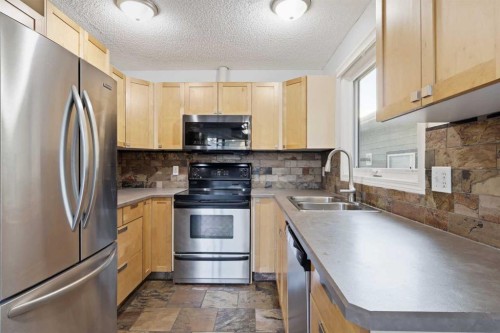 4712 60 Street Ne, Calgary, AB - Indoor Photo Showing Kitchen With Double Sink