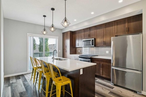 102 Shawnee Common Sw, Calgary, AB - Indoor Photo Showing Kitchen With Stainless Steel Kitchen With Double Sink With Upgraded Kitchen