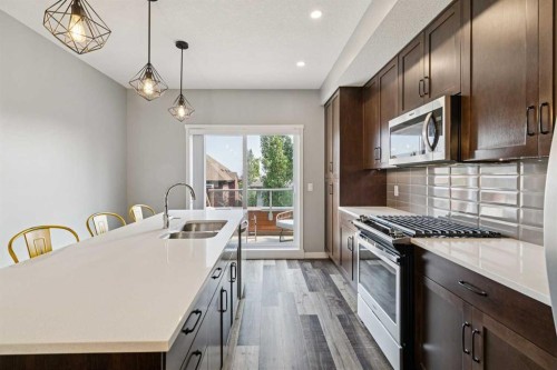 102 Shawnee Common Sw, Calgary, AB - Indoor Photo Showing Kitchen With Double Sink With Upgraded Kitchen