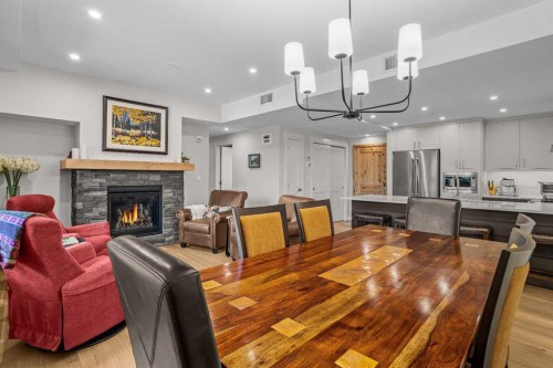 307-1505 Spring Creek Gate, Canmore, AB - Indoor Photo Showing Dining Room With Fireplace