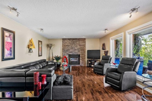 85 Sunset Way Se, Calgary, AB - Indoor Photo Showing Living Room With Fireplace