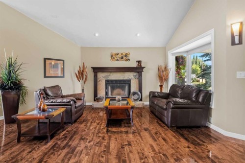 85 Sunset Way Se, Calgary, AB - Indoor Photo Showing Living Room With Fireplace