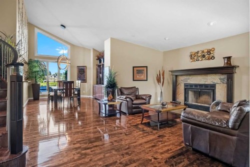 85 Sunset Way Se, Calgary, AB - Indoor Photo Showing Living Room With Fireplace