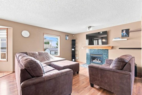 610 Saddlecreek Way Ne, Calgary, AB - Indoor Photo Showing Living Room With Fireplace