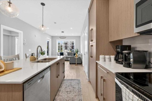 2112-681 Savanna Boulevard Ne, Calgary, AB - Indoor Photo Showing Kitchen With Double Sink
