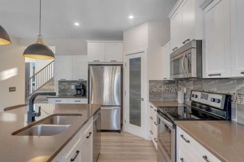 156 Rainbow Falls Heath, Chestermere, AB - Indoor Photo Showing Kitchen With Double Sink With Upgraded Kitchen