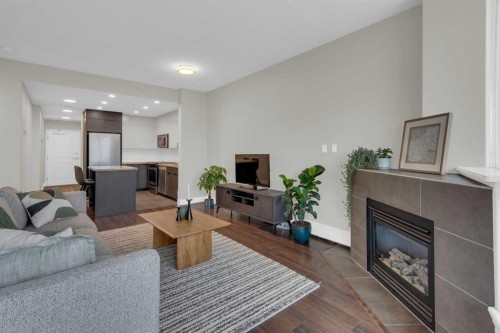 1103-77 Spruce Place Sw, Calgary, AB - Indoor Photo Showing Living Room With Fireplace