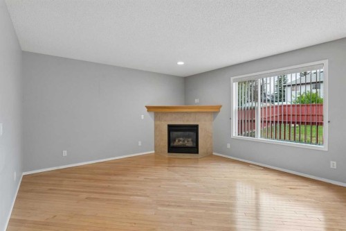 22 Somerside Crescent Sw, Calgary, AB - Indoor Photo Showing Living Room With Fireplace