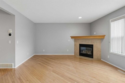 22 Somerside Crescent Sw, Calgary, AB - Indoor Photo Showing Living Room With Fireplace