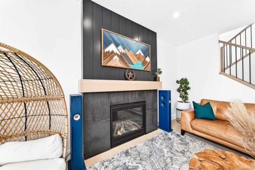 24 Emerson Crescent, Okotoks, AB - Indoor Photo Showing Living Room With Fireplace