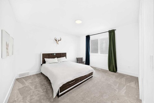 24 Emerson Crescent, Okotoks, AB - Indoor Photo Showing Bedroom