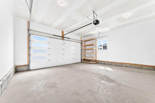 79 Sundown Way, Cochrane, AB - Indoor Photo Showing Garage