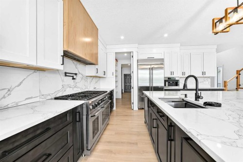 79 Sundown Way, Cochrane, AB - Indoor Photo Showing Kitchen With Double Sink With Upgraded Kitchen