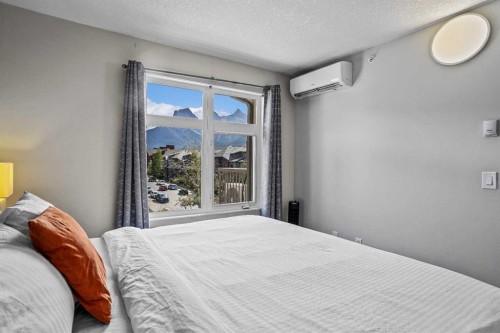 401-160 Kananaskis Way, Canmore, AB - Indoor Photo Showing Bedroom