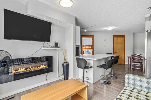 401-160 Kananaskis Way, Canmore, AB - Indoor Photo Showing Other Room With Fireplace