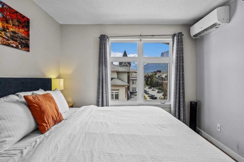 401-160 Kananaskis Way, Canmore, AB - Indoor Photo Showing Bedroom