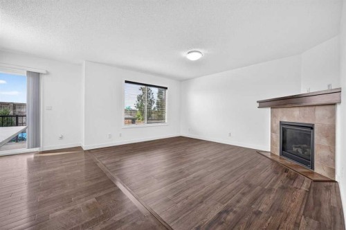 377 Panora Way Nw, Calgary, AB - Indoor Photo Showing Living Room With Fireplace