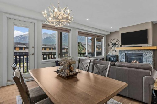 311-1315 Spring Creek Gate, Canmore, AB - Indoor Photo Showing Dining Room With Fireplace