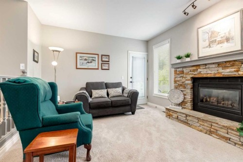 15 Sunrise Crescent Se, Calgary, AB - Indoor Photo Showing Living Room With Fireplace