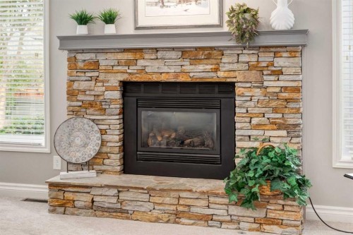 15 Sunrise Crescent Se, Calgary, AB - Indoor Photo Showing Living Room With Fireplace