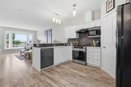 402-703 Luxstone Square Sw, Airdrie, AB - Indoor Photo Showing Kitchen With Upgraded Kitchen