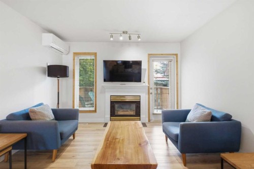 114-1720 Bow Valley Trail, Canmore, AB - Indoor Photo Showing Living Room With Fireplace