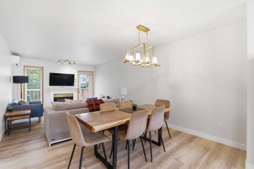 114-1720 Bow Valley Trail, Canmore, AB - Indoor Photo Showing Dining Room With Fireplace