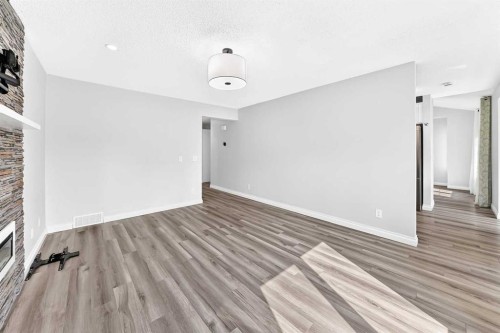 147 Macewan Drive Nw, Calgary, AB - Indoor Photo Showing Other Room With Fireplace
