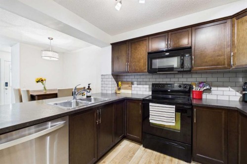 936 Windsong Drive Sw, Airdrie, AB - Indoor Photo Showing Kitchen With Double Sink