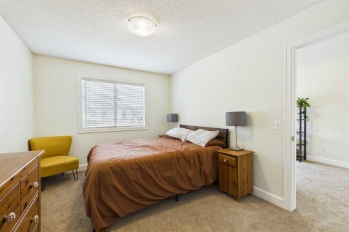 936 Windsong Drive Sw, Airdrie, AB - Indoor Photo Showing Bedroom
