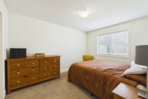 936 Windsong Drive Sw, Airdrie, AB - Indoor Photo Showing Bedroom