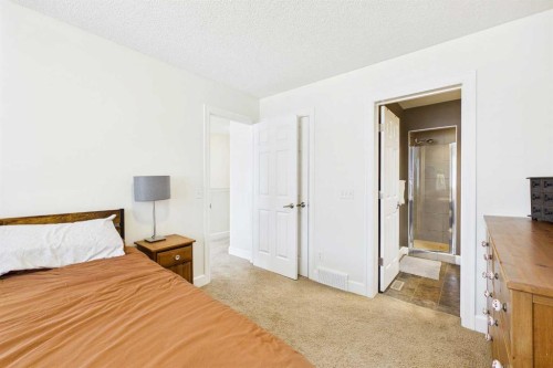 936 Windsong Drive Sw, Airdrie, AB - Indoor Photo Showing Bedroom